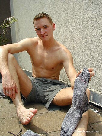 Mr. Gay London shows off his socks and feet