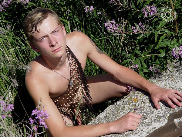 Kon poses in a net outside, looking like a caught fish