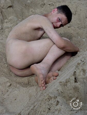 Fima enjoys rolling in the sand while completely naked