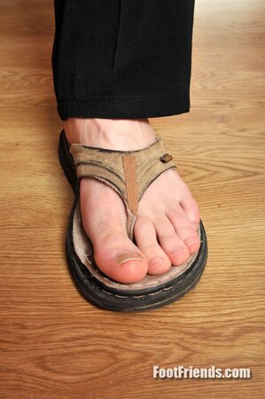 Peter reveals his short toes while cooking in the kitchen