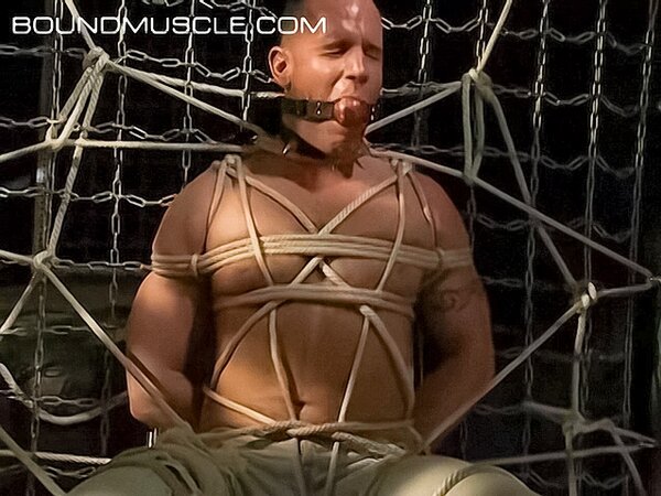 Bound Bigg Pete can't speak with a ball gag in his mouth