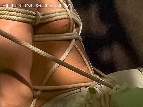 Bound Bigg Pete flexes his huge biceps in rope bondage