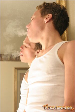 Justin smokes and strokes his cock until he cums