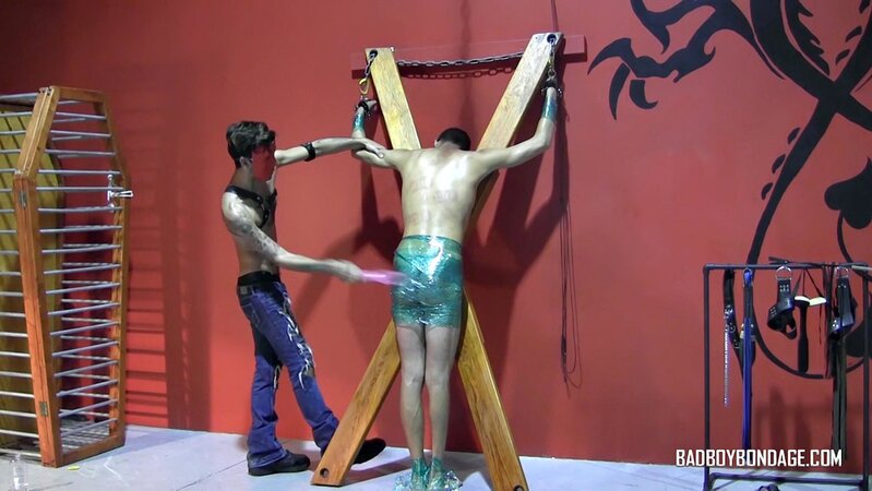 Ryann Ruckers torments Justin Martinez on the bondage cross