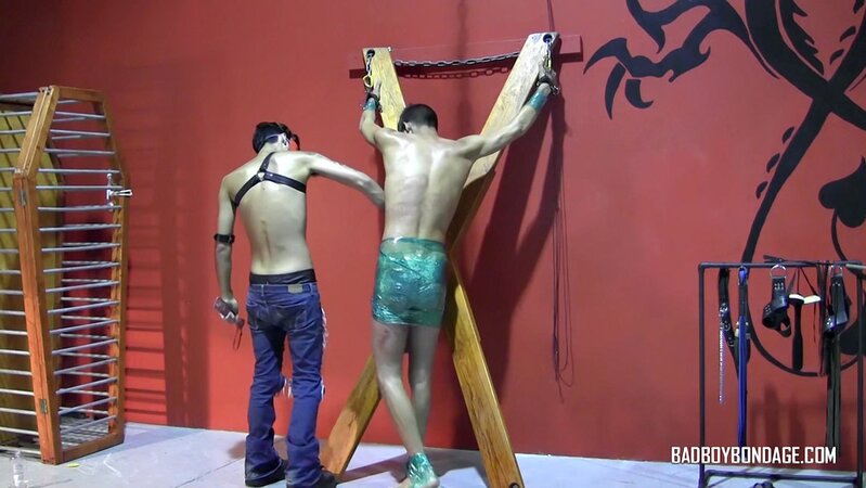 Ryann Ruckers torments Justin Martinez on the bondage cross