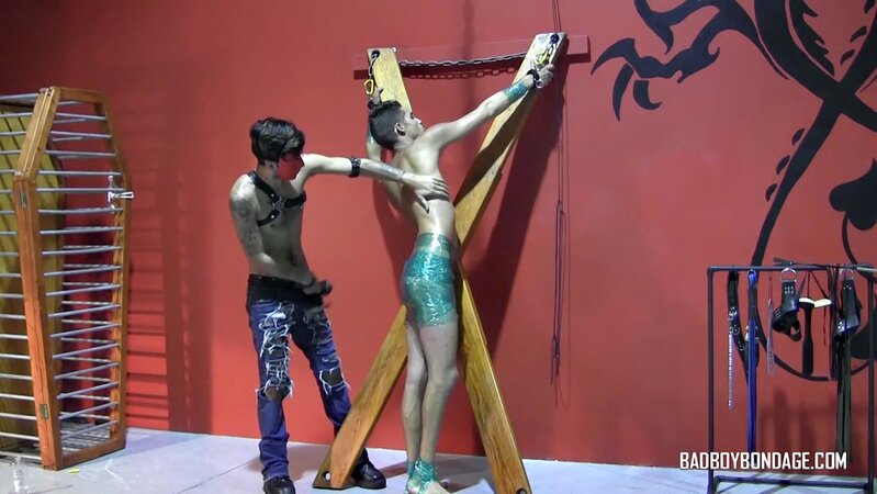 Ryann Ruckers torments Justin Martinez on the bondage cross