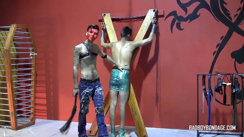 Ryann Ruckers torments Justin Martinez on the bondage cross