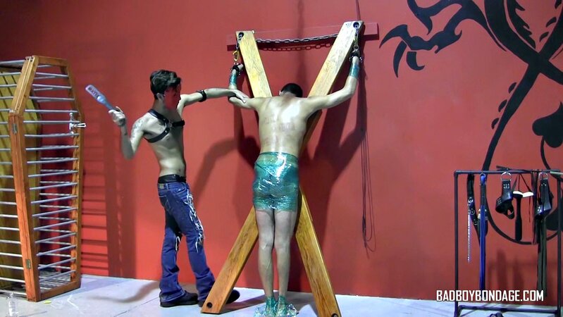 Ryann Ruckers torments Justin Martinez on the bondage cross