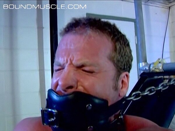 Dire Callahan chains down muscle man Derek Pain in bondage