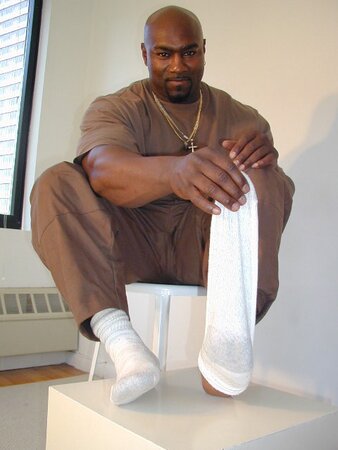 Black and muscled Dynamite shows off bare feet