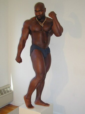 Black and muscled Dynamite shows off bare feet