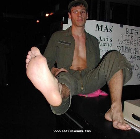 Robert greets men at the door while showing off his sexy bare feet