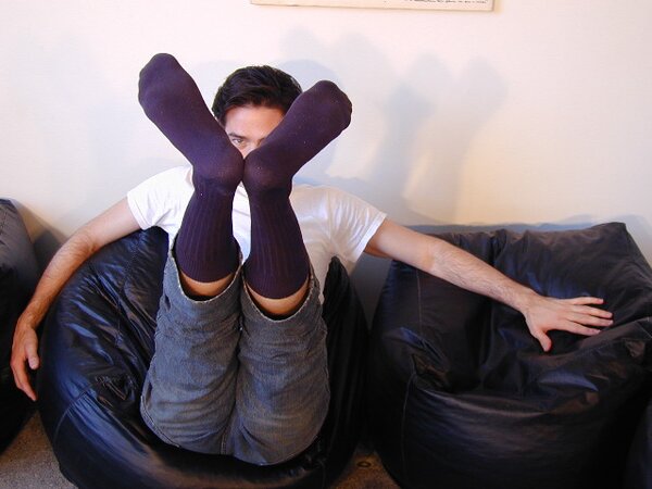 Brunette Christopher flaunts his feet in dark socks for the camera