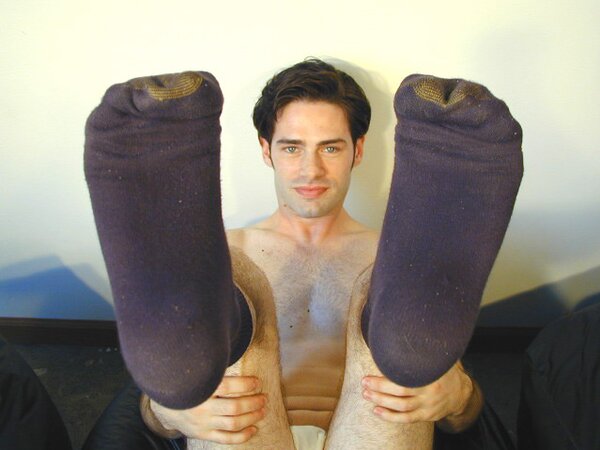 Brunette Christopher flaunts his feet in dark socks for the camera