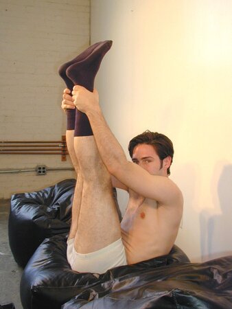 Brunette Christopher flaunts his feet in dark socks for the camera