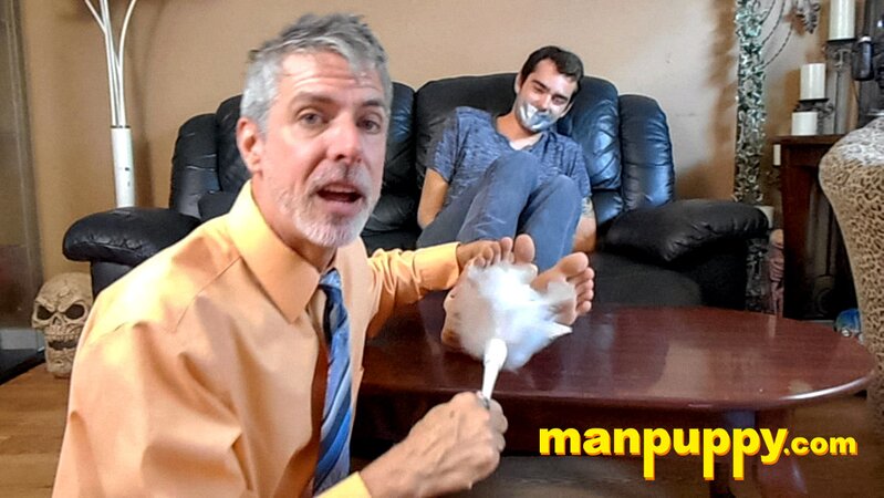 Kody Tracer squirms as Richard Lennox tickles with brush