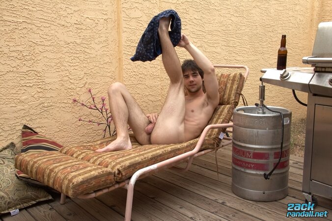 Beer in hand, Zack Randall jerks his uncut cock and cums on the keg