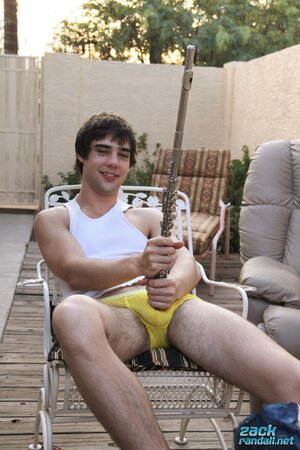 Zack Randall plays his flute and slips the mouthpiece into his foreskin