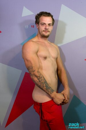 Muscular and tattooed, Jimmy Longdong strokes his cock in the bedroom