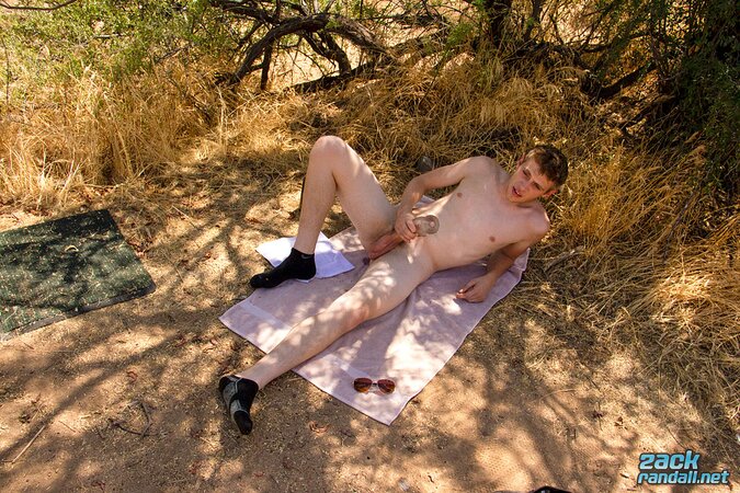 Straight Oliver Dean strokes his big cock in nature