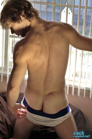 Stroking Zack Randall shoots cum from his hooded dick