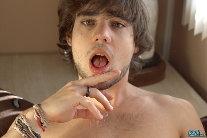 Stroking Zack Randall shoots cum from his hooded dick