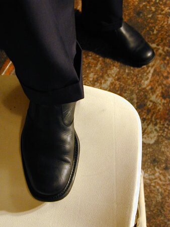 Eric’s slim feet and sheer dark socks steal the show