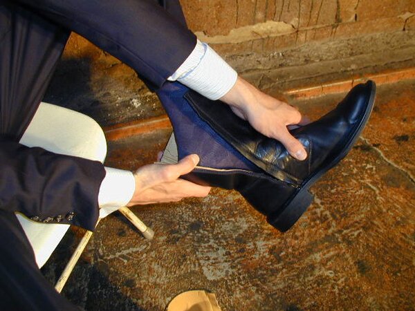 Eric’s slim feet and sheer dark socks steal the show
