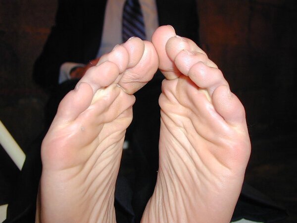 Eric’s slim feet and sheer dark socks steal the show