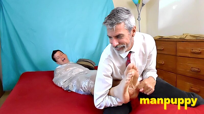 Richard Lennox drives Jeff Drizzle crazy tickling his toes through plastic