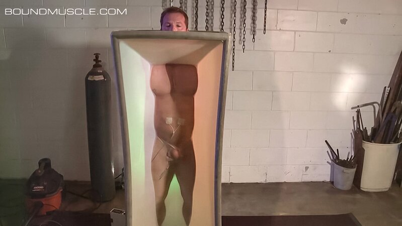 Dire Callahan traps Derek Pain in a latex coffin for pain play