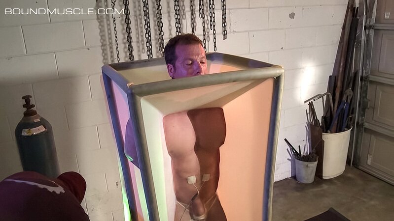 Dire Callahan traps Derek Pain in a latex coffin for pain play