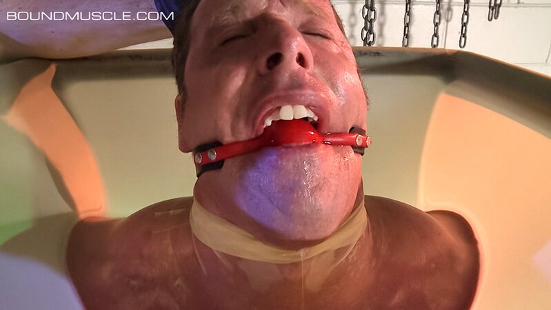 Dire Callahan traps Derek Pain in a latex coffin for pain play