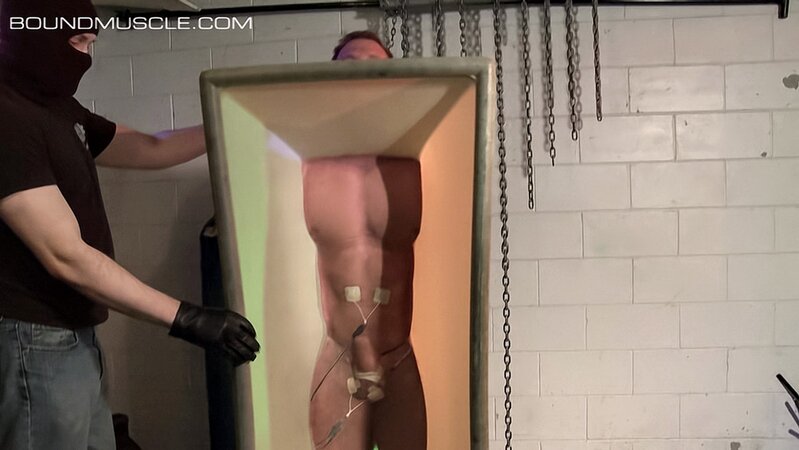 Dire Callahan traps Derek Pain in a latex coffin for pain play