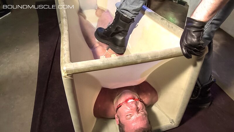 Dire Callahan traps Derek Pain in a latex coffin for pain play