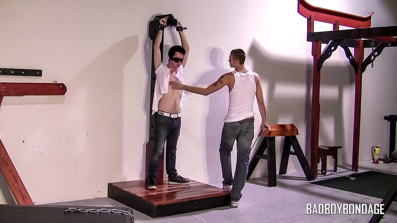 Clint spanks blindfolded Trevor in bondage wall scene