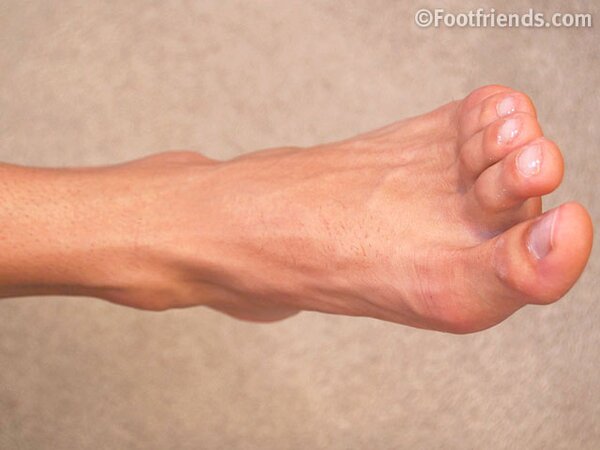 Brandon Fox leans back on sofa, jerking off and flashing his size 11 feet