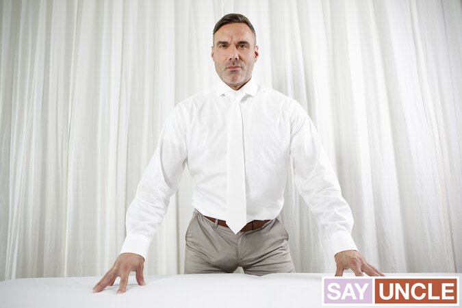 Good-boy Benjamin Blue bends for President Manuel Skye's anointing massage