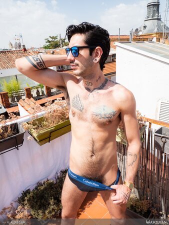 Alexis Clark jerks off hairy cock on the sunny rooftop