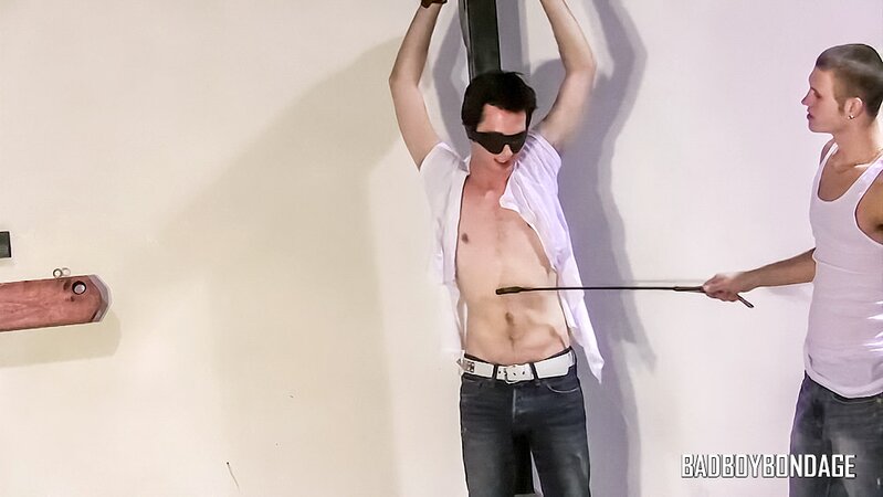 Clint chains blindfolded Trevor and paddles his cock