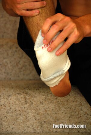 Tied Bradley plays with dirty feet for the camera