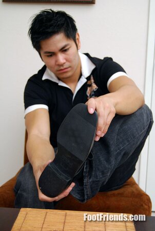 Asian muscle Scorpio shows off big feet in black socks