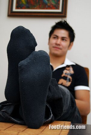 Asian muscle Scorpio shows off big feet in black socks