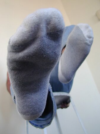 Anthony sniffs his musky leather boots and gray socks