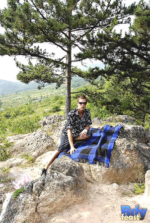 Dillon strips naked outdoors and strokes slim cock