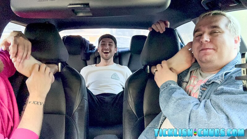 Dimitri giggles as Ryder and Matt tickle his propped-up feet