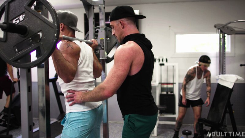 Personal trainer Nick Fitt gets real close to client Roman Todd at the gym