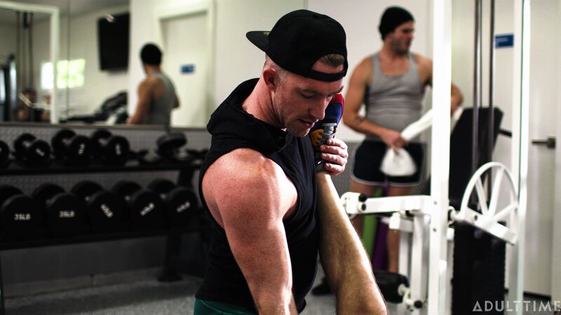 Personal trainer Nick Fitt gets real close to client Roman Todd at the gym