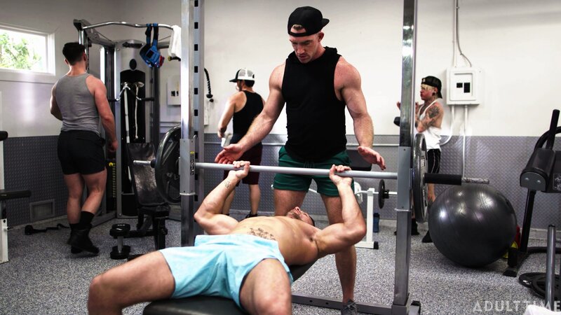 Personal trainer Nick Fitt gets real close to client Roman Todd at the gym