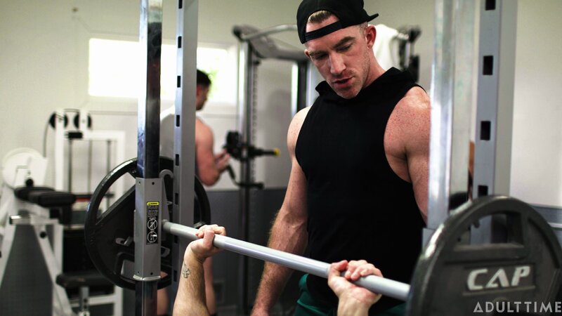 Personal trainer Nick Fitt gets real close to client Roman Todd at the gym